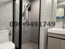 Modern bathroom with glass shower and well-lit vanity area