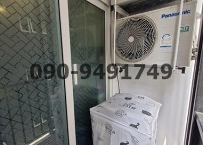 Compact utility area with air conditioning units and packaged item