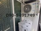 Compact utility area with air conditioning units and packaged item