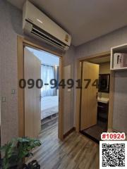 Cozy bedroom with modern air conditioning unit and wooden flooring