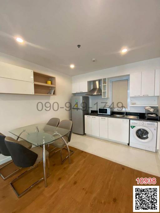 Modern kitchen with dining area and laundry facilities