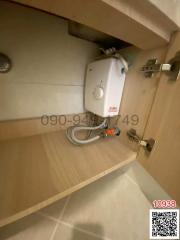 Compact bathroom water heater unit mounted under a cabinet