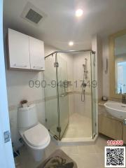 Modern bathroom interior with glass shower, toilet, and basin