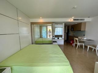 Bright modern studio bedroom with integrated kitchen and mirrored wardrobe