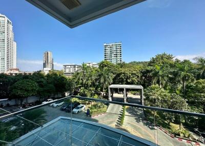 Spacious balcony with a view of the city skyline and greenery