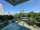 Spacious balcony with a view of the city skyline and greenery