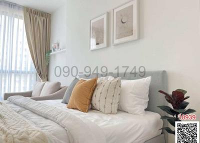 Cozy and bright bedroom with a double bed and decorative plants