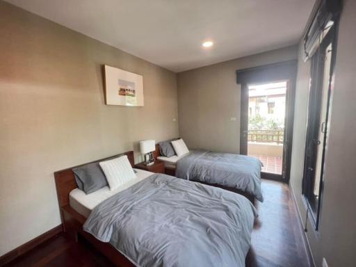 Spacious bedroom with twin beds and balcony access