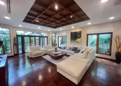 Spacious living room with hardwood floors, ceiling design, and ample natural light