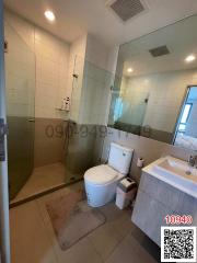 Modern bathroom interior with glass shower and white fixtures