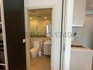 Bathroom with white fixtures and a glass shower door