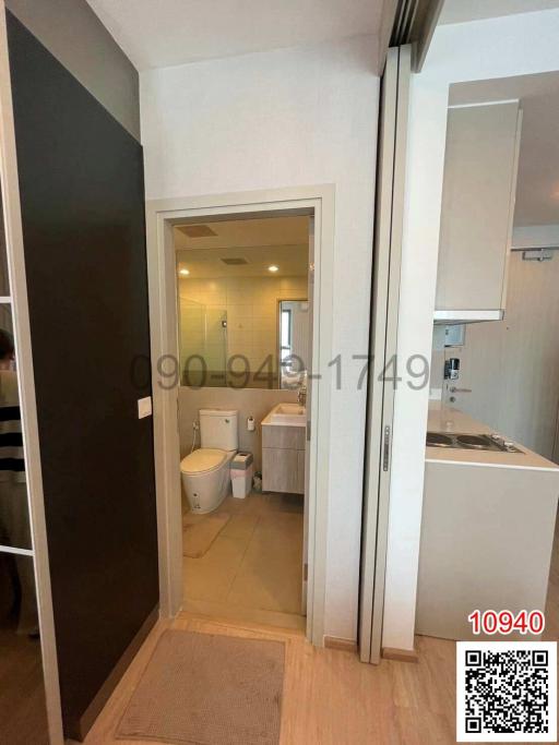 Bathroom with white fixtures and a glass shower door