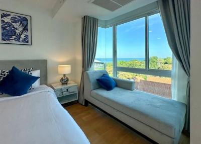 Bright and airy bedroom with a view of the sea