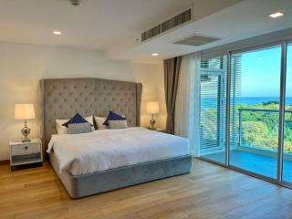 Bright and airy bedroom with king-sized bed and ocean view