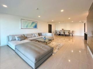 Spacious and modern living room with large sectional sofa, dining area, and open floor plan