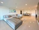 Spacious and modern living room with large sectional sofa, dining area, and open floor plan