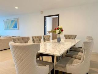 Modern dining area with elegant marble table and plush chairs