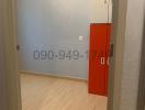 Empty bedroom with an orange cabinet and wooden flooring