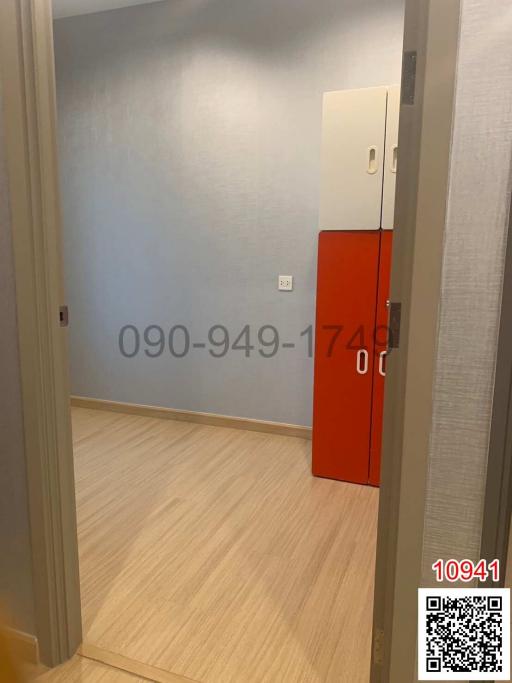 Empty bedroom with an orange cabinet and wooden flooring