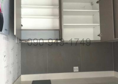 Modern kitchen interior with empty shelves and closed cupboards