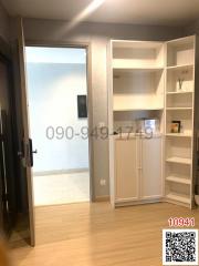 Well-lit entrance or foyer area with storage shelves and a cupboard unit