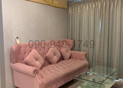 Cozy living room with pink sofa and artistic wall decor