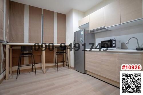 Modern kitchen with wooden floors, built-in cabinets, and stainless steel appliances