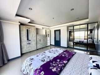 Spacious bedroom with modern furnishings and ample natural light