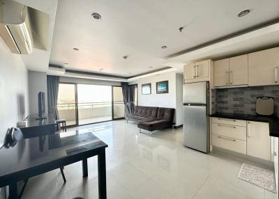 Spacious open-plan living room and kitchen with modern appliances and ample natural light