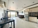 Spacious open-plan living room and kitchen with modern appliances and ample natural light