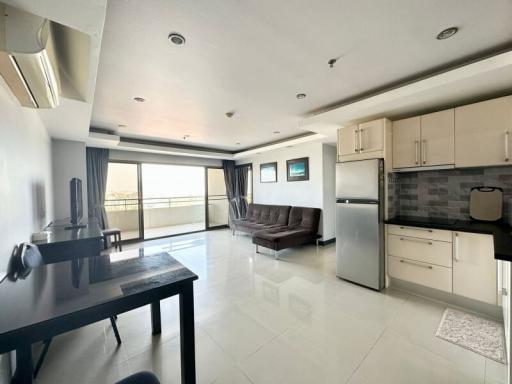 Spacious open-plan living room and kitchen with modern appliances and ample natural light