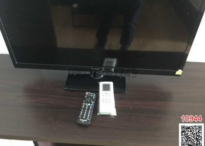 Television with remote controls in a living room setting