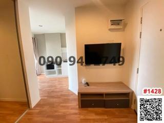 Spacious living room with mounted television and wooden flooring