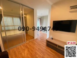 Cozy Living Room with Balcony Access and Mounted Television