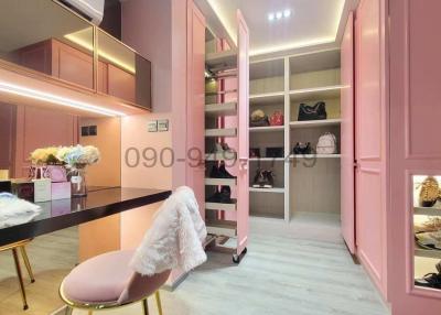 Elegant pink-themed bedroom with walk-in closet and makeup vanity