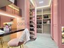 Elegant pink-themed bedroom with walk-in closet and makeup vanity