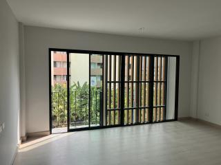 Spacious living room with large window and natural light