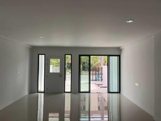 Spacious and well-lit living room with sliding glass doors and a view of the patio