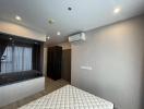 Spacious bedroom with modern design, ample lighting, and air conditioning