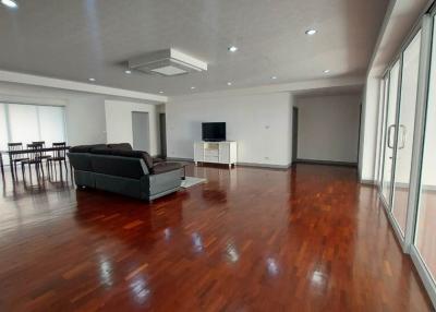 Spacious living room with glossy hardwood floors and contemporary furniture