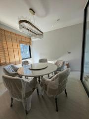 Modern dining room with a round table and comfortable chairs