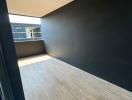 Modern corridor with wooden flooring and contrasting walls