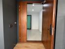 Modern home entrance with wooden door and tiled flooring