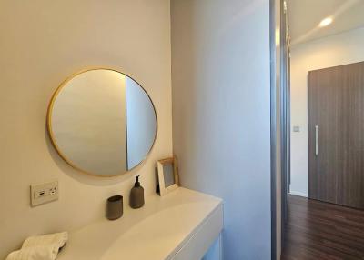 Modern bathroom with round mirror and minimalist vanity