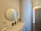 Modern bathroom with round mirror and minimalist vanity