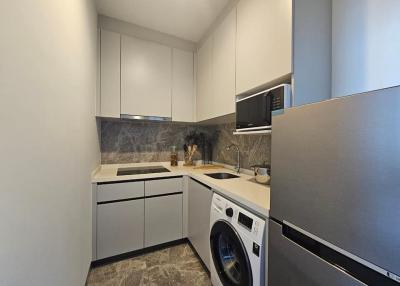 Modern kitchen with stainless steel appliances and marble countertop