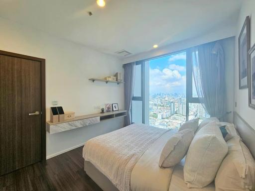 Cozy bedroom with a city view and natural lighting