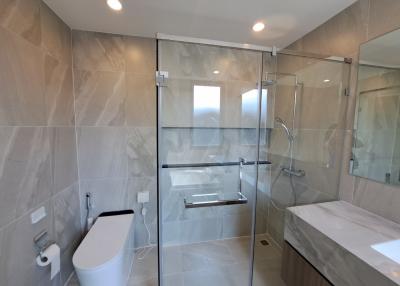 Modern bathroom with glass shower enclosure and bathtub