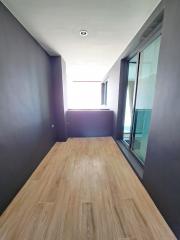 Modern hallway with wooden flooring and ample natural light