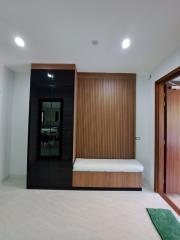 Modern bedroom with built-in wardrobe and entrance to the bathroom